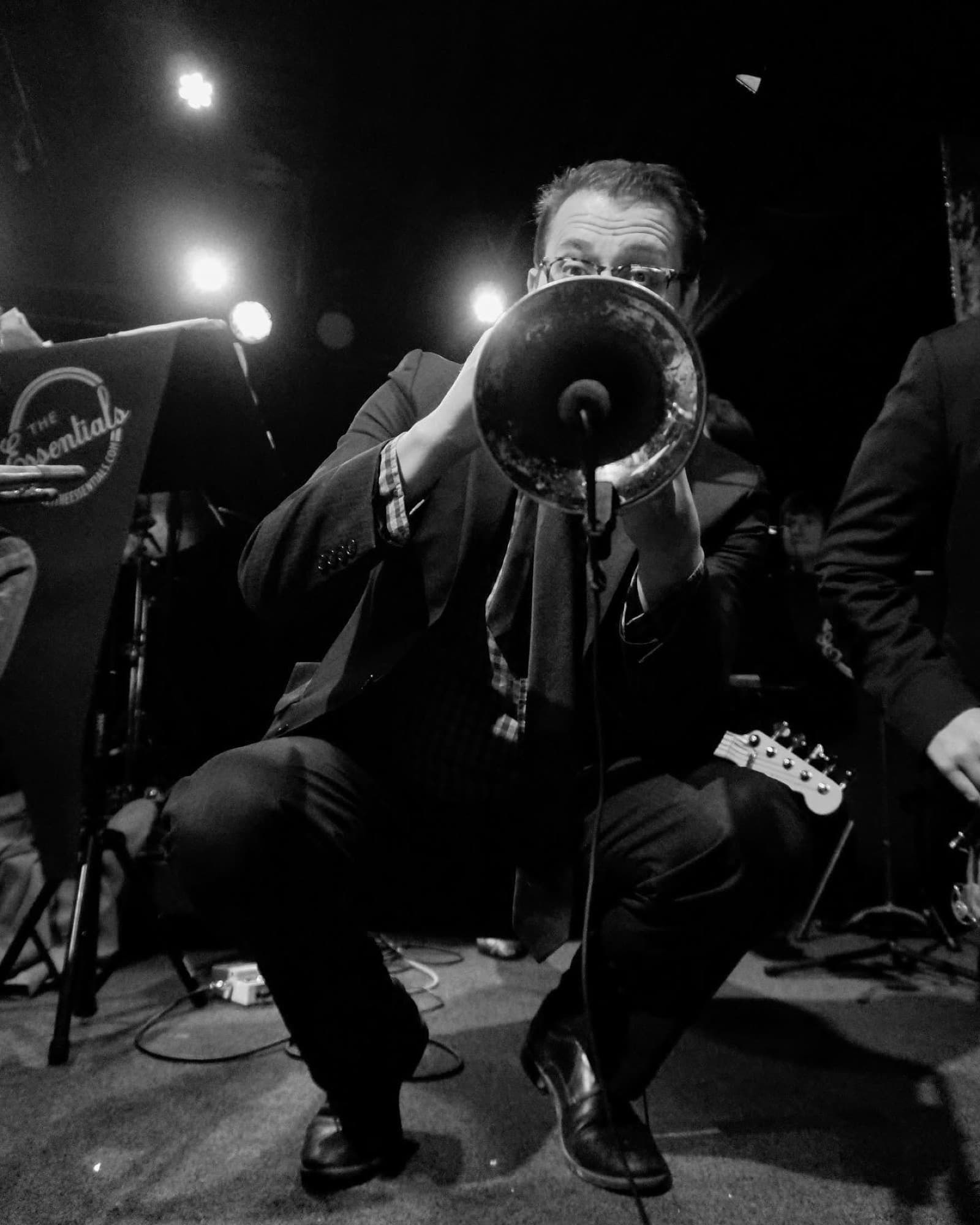 Black and white close-up of Reid Poole playing trumpet