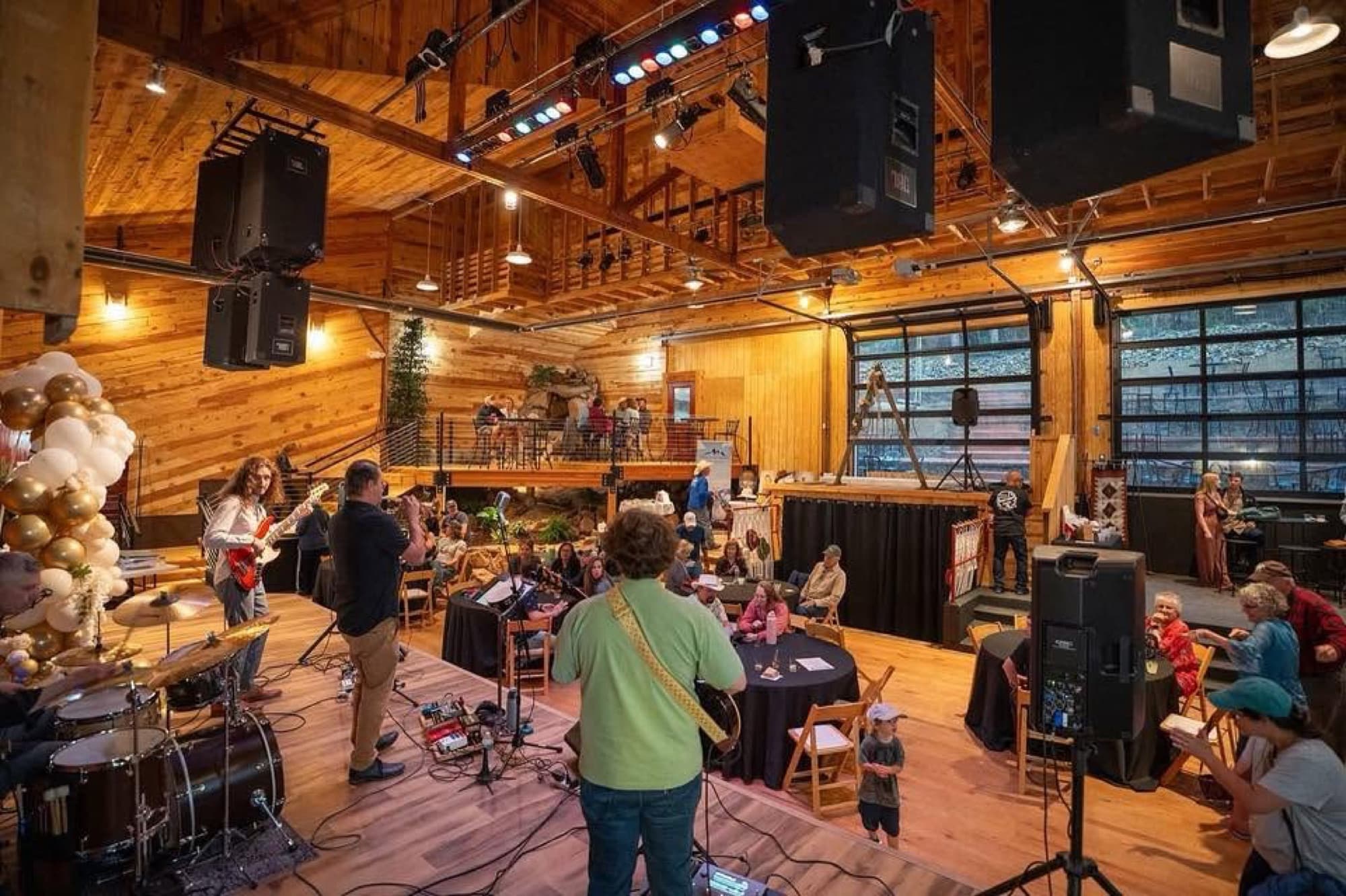 A live band performing in a large wooden event space