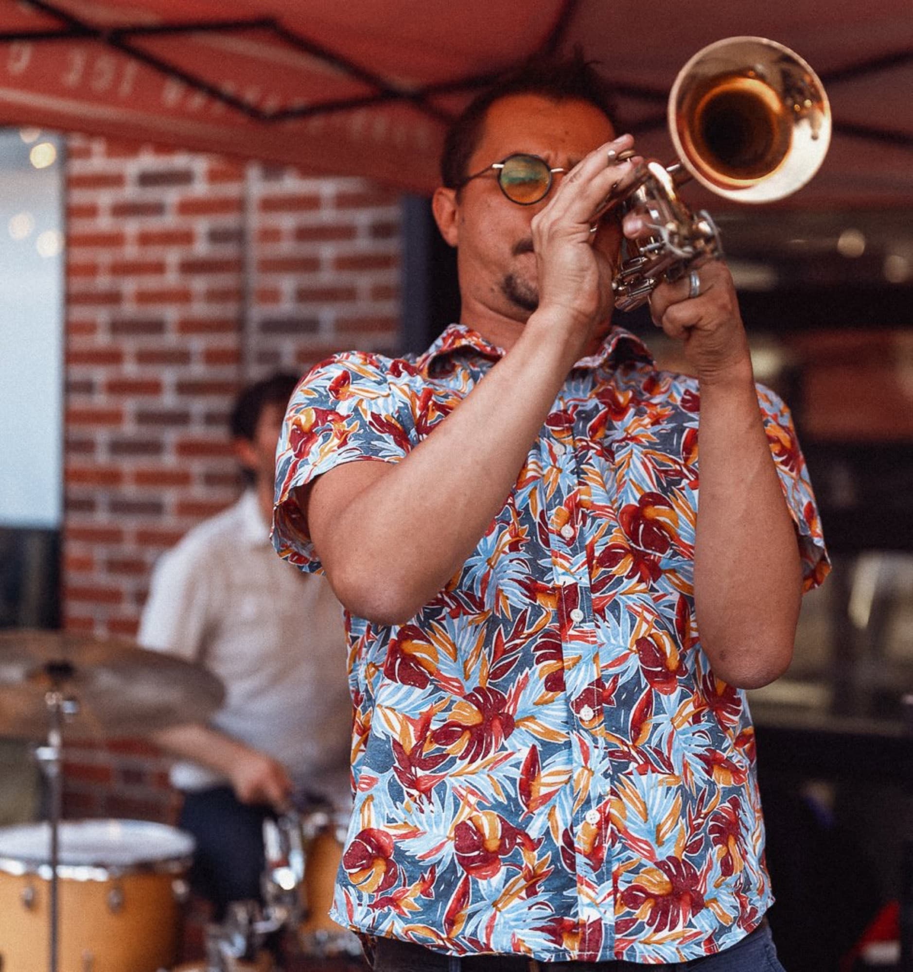 Reid Poole playing trumpet in a floral shirt