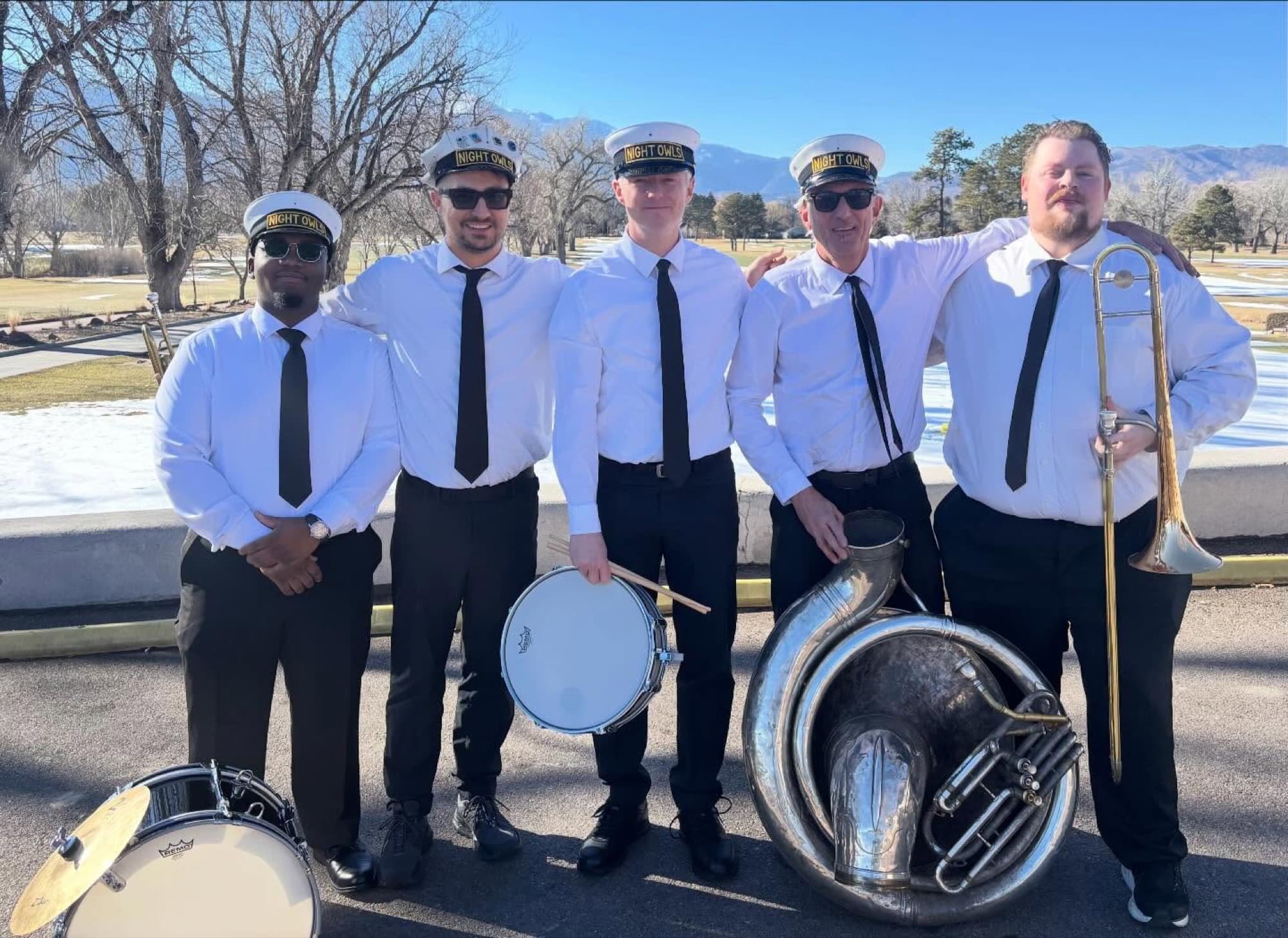 The Night Owls standing together in matching band uniforms